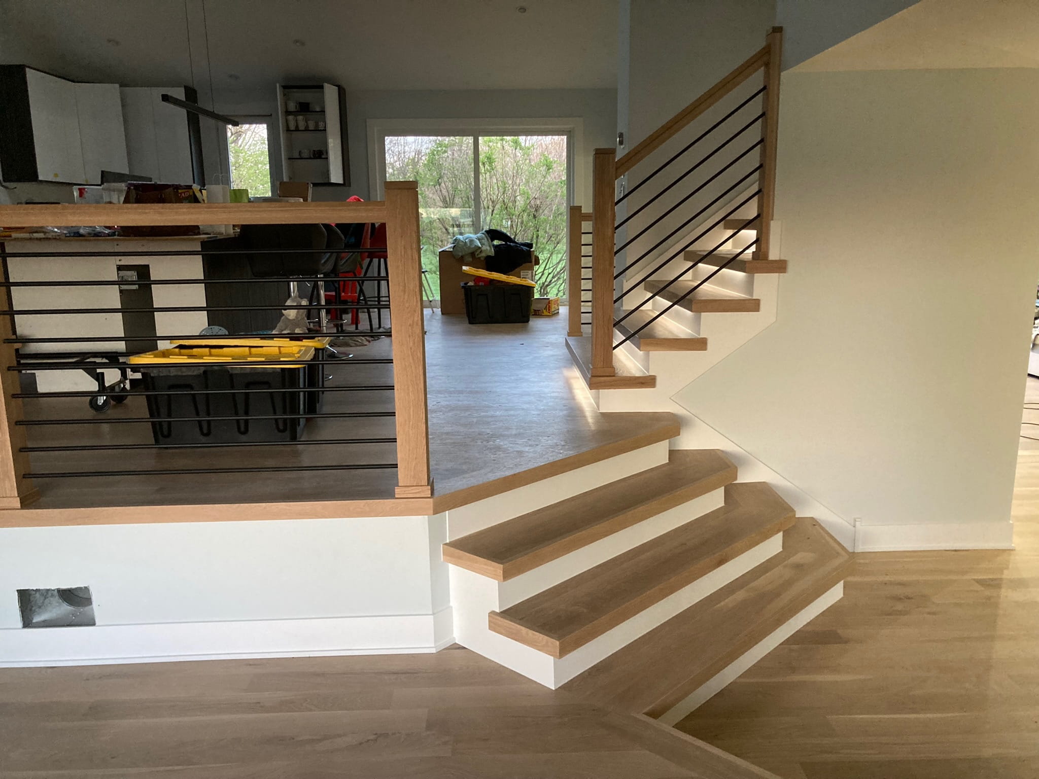 After: same staircase area with completed railing and cleaner finish