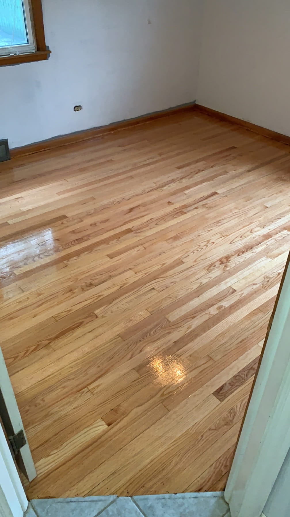 After: same room with freshly refinished hardwood floor
